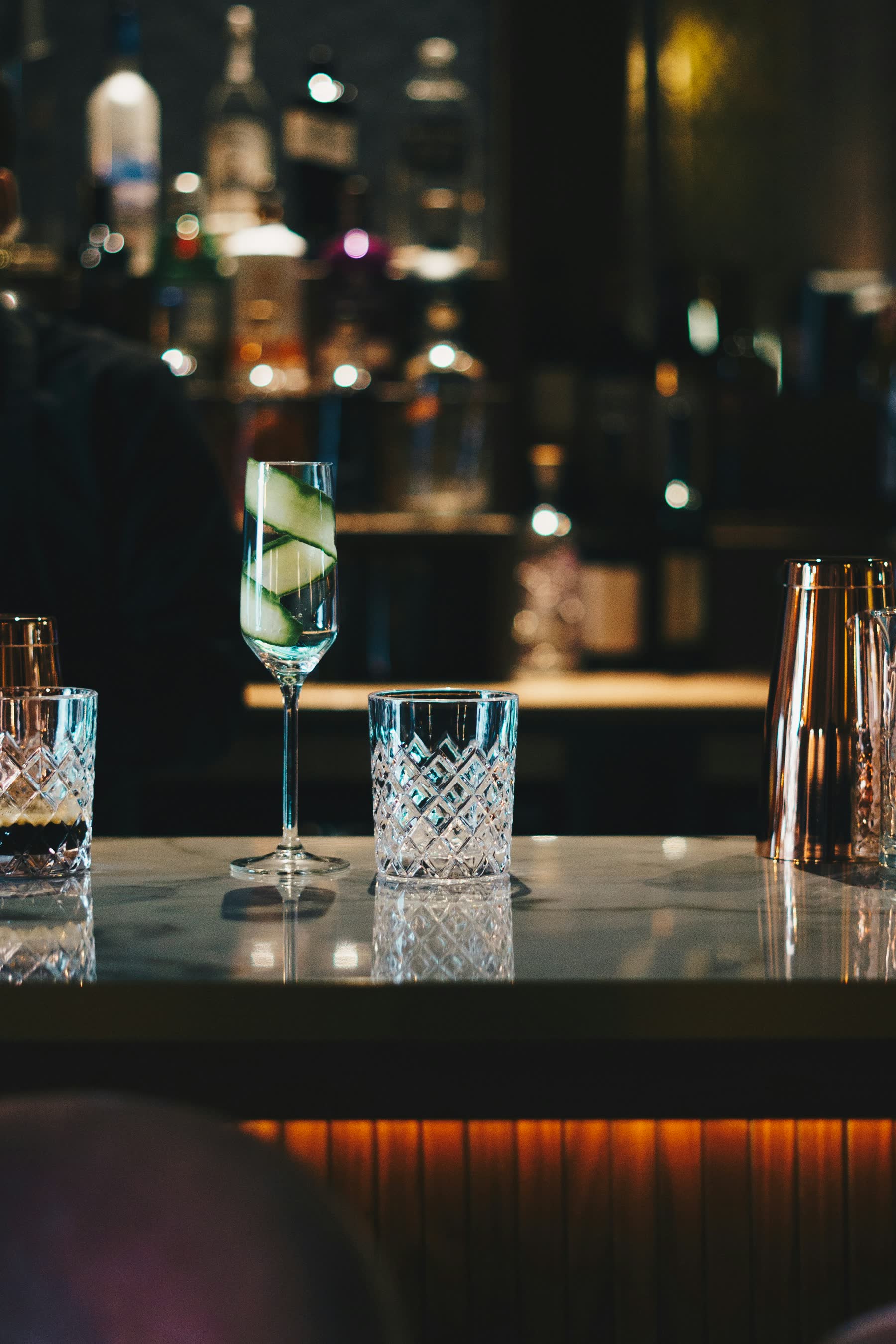A cocktail on a marble bar counter